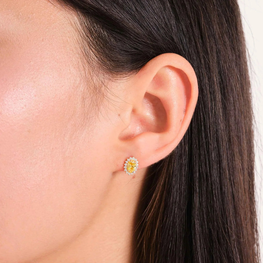 14K yellow gold lab-grown citrine halo stud earring on ear, side profile close-up