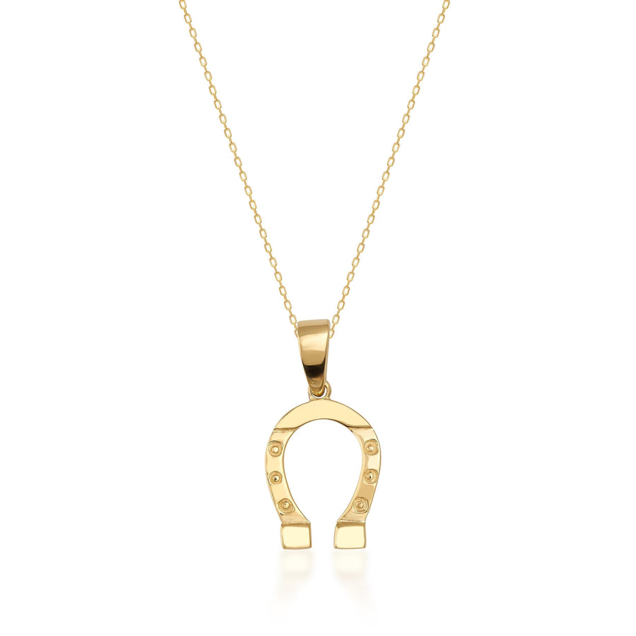 Collier fer à cheval en or jaune 14 carats sur fond blanc