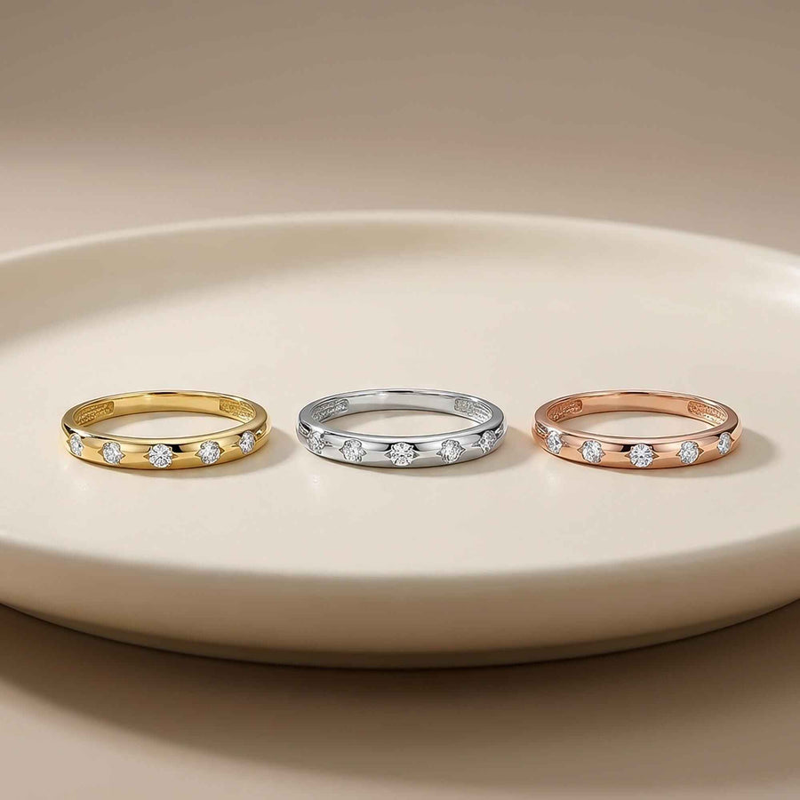 14K yellow, white and rose gold CZ band rings on a white plate