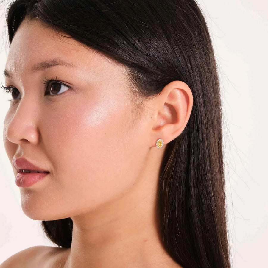 14K gold lab-grown citrine halo stud earring worn on model, three-quarter view of face