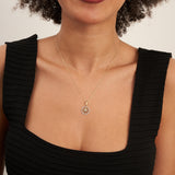 Model in black top wearing a 14K yellow gold compass star necklace