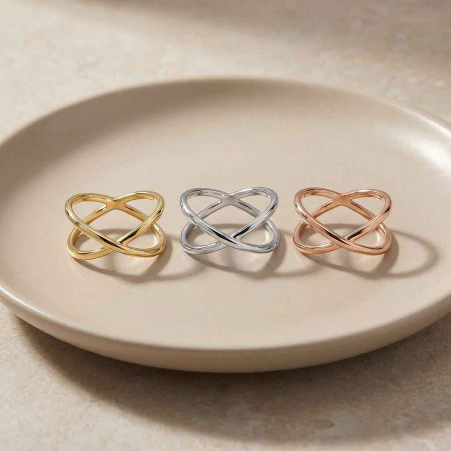 Bagues infini entrecroisées en or jaune, blanc et rose 14 carats alignées sur une assiette