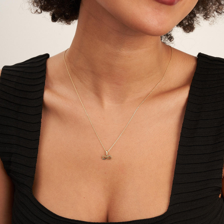 14K yellow gold infinity necklace worn on model, front view