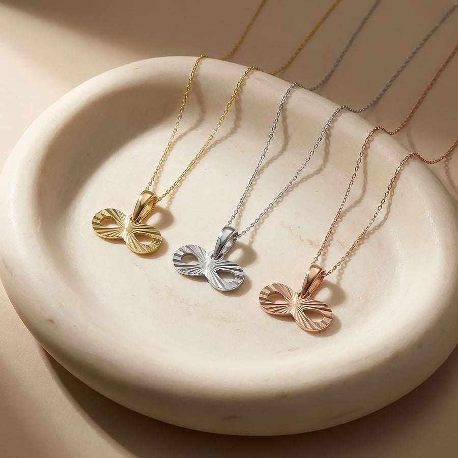 14K yellow, white and rose gold infinity necklaces in a round stone dish