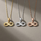 14K yellow, white and rose gold diamond-cut infinity pendants side by side