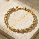 Bracciale a corda largo in oro giallo 14kt su travertino